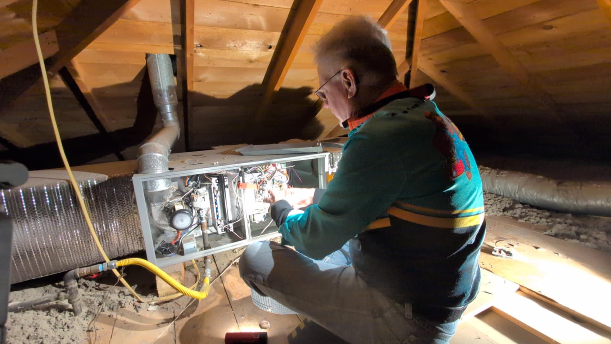 The image depicts a professional performing Maintenance on a residential gas furnace. Regular maintenance will extend the life of your equipment, save on utility costs, prevent emergency losses of heating at the coldest times of the year and keep you comfortably warm all winter headache free.